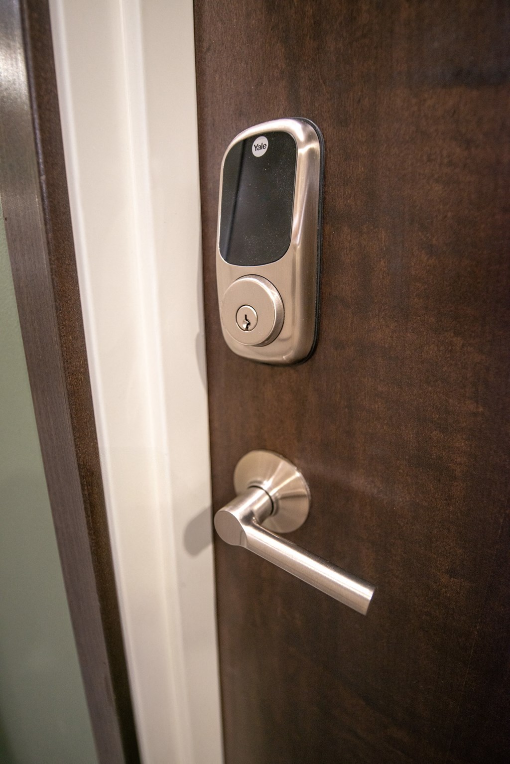 an open door with a door handle and a smart door lock