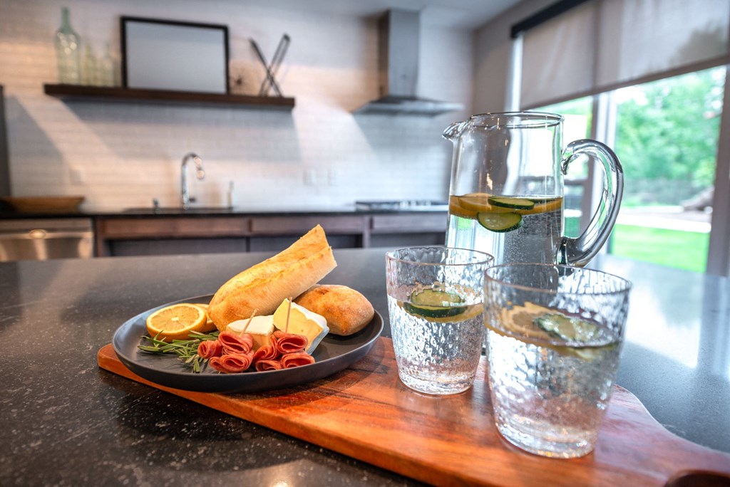 a table with a plate of food and a glass of water on it