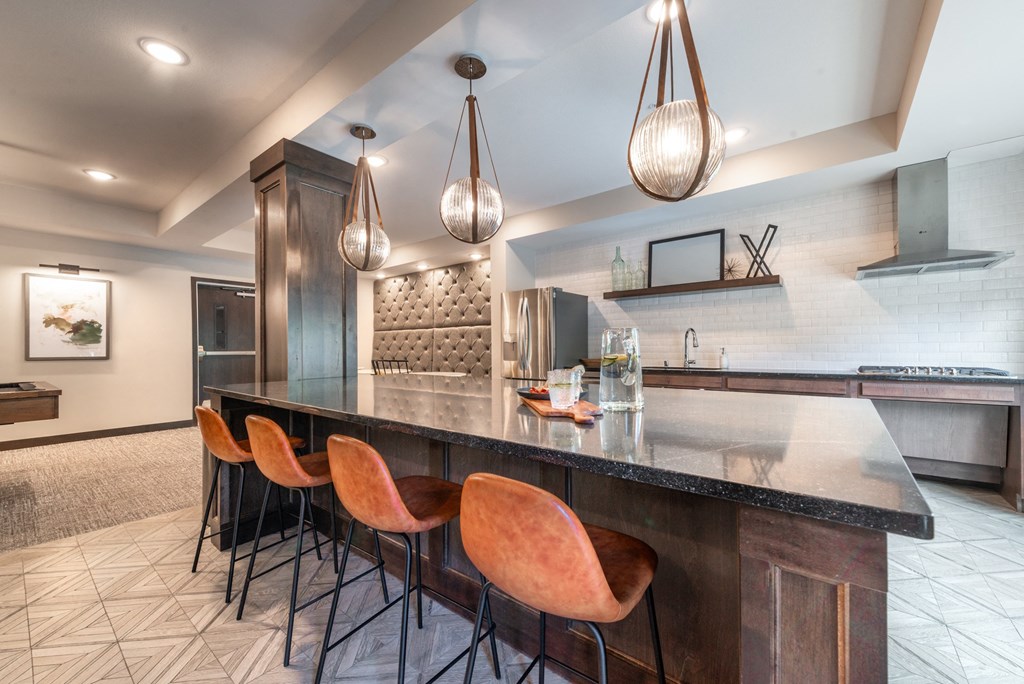a kitchen with a counter top and chairs