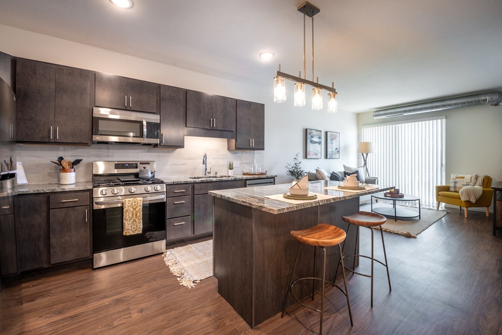 an open kitchen and living room with a table and chairs