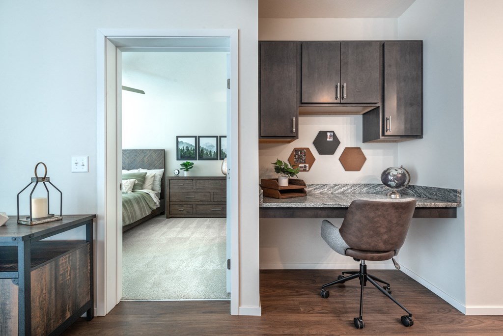 a home office with a desk and a bedroom