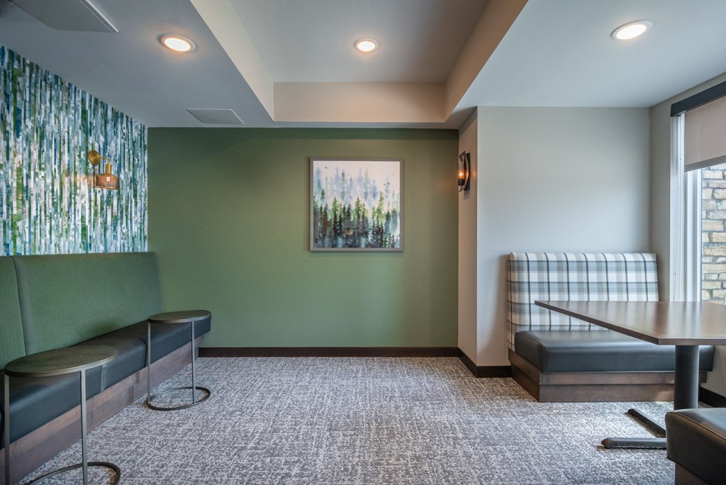 a room with a couch and a table and a painting on the wall