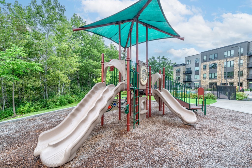 a playground with slides and a tent