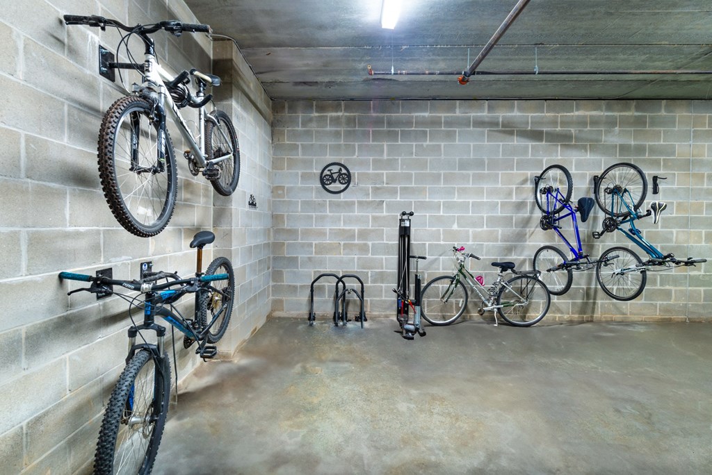 two bikes hanging on the wall of a bike garage