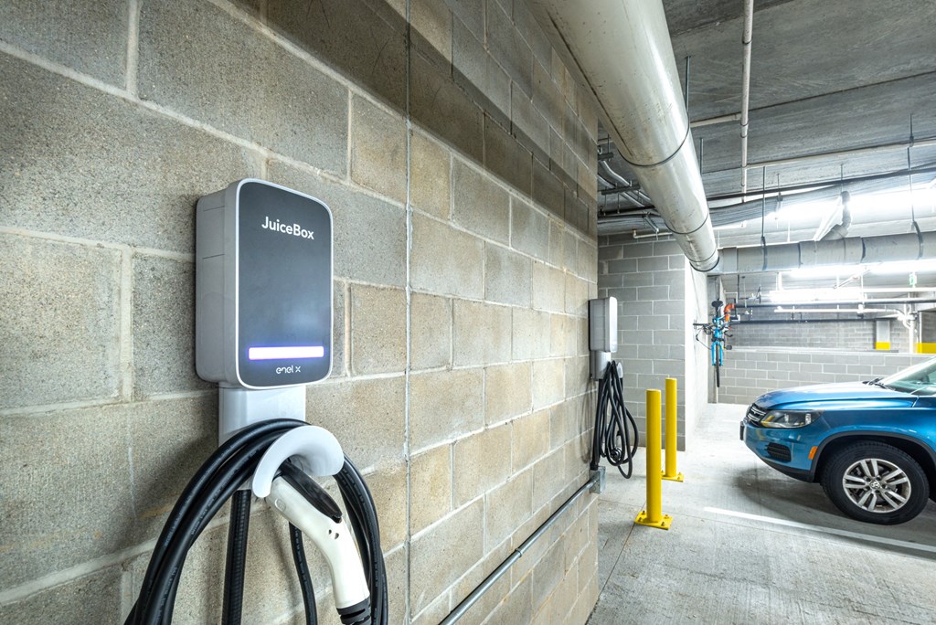 a car is parked at a charging station in a parking garage