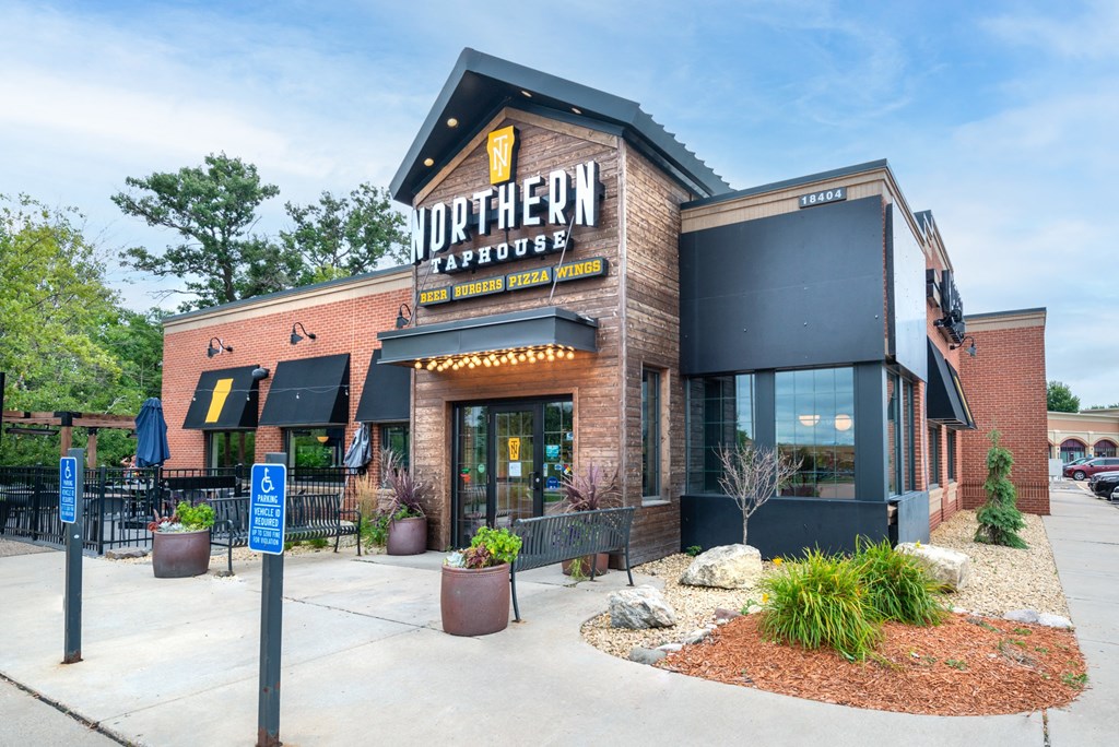 the exterior of a restaurant with a sign on the side of the building