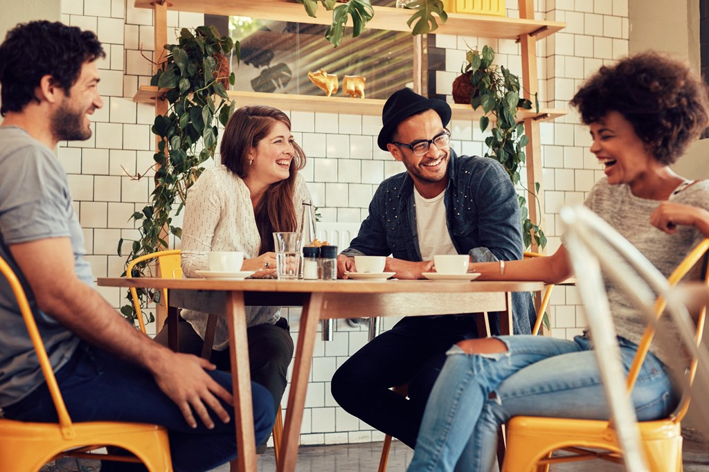 a group of people sitting at a table in a restaurant