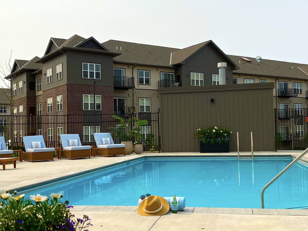 a swimming pool at the west end lodge apartments in beaumont, tx