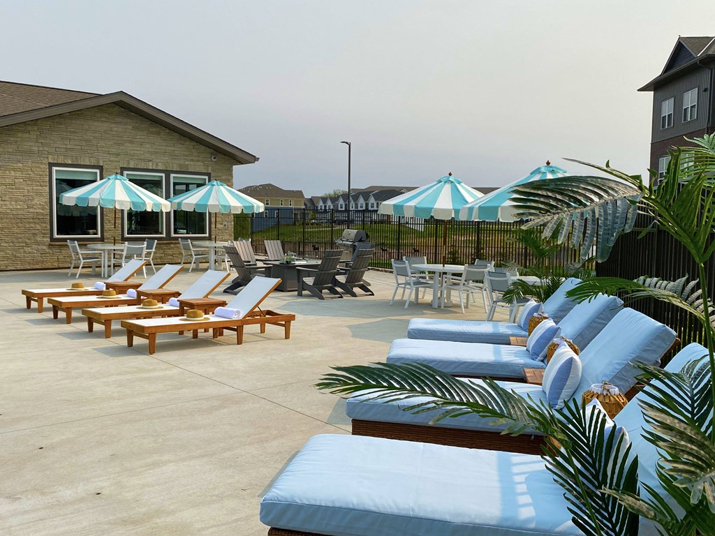 a pool with lounge chairs and umbrellas