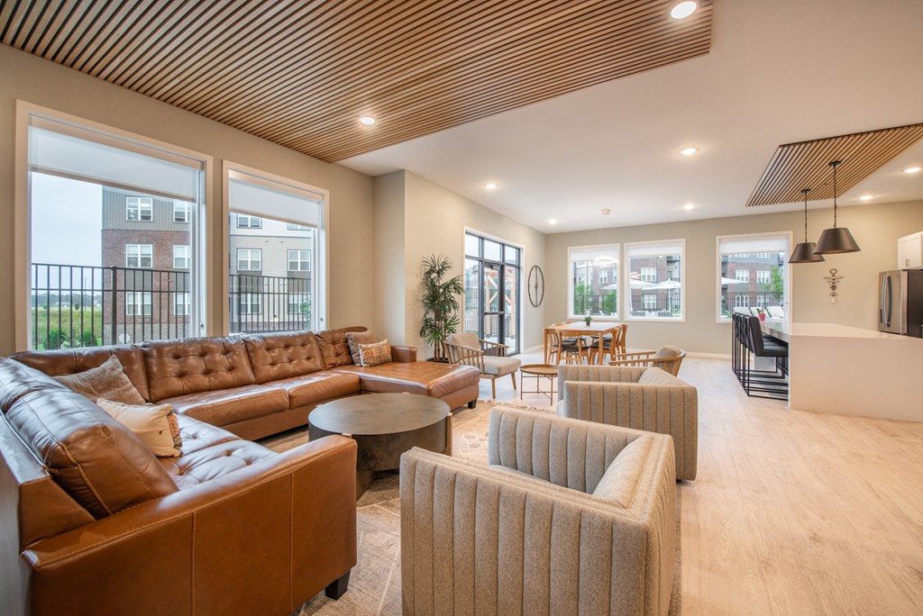 a large living room with couches and chairs and a table