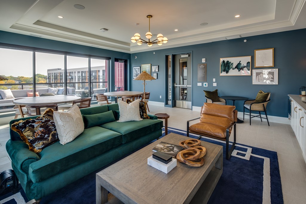 a living room with blue walls and a green couch