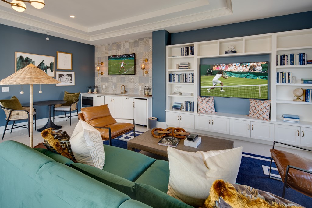 a living room with a blue couch and a tv