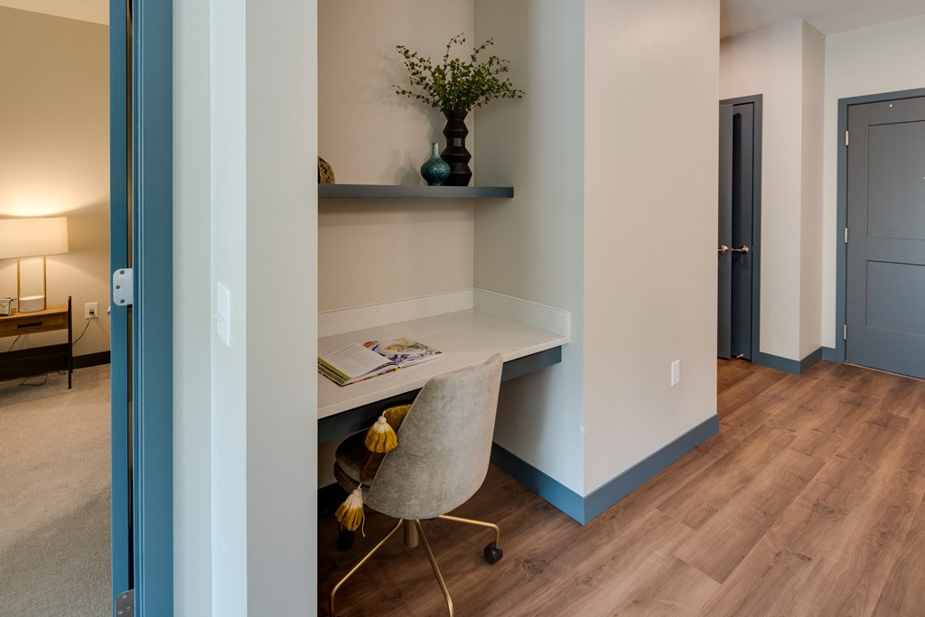 a home office with a desk and a chair