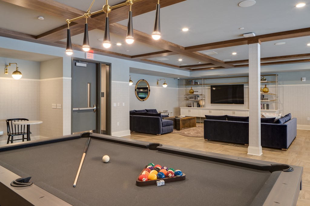 a rec room with a pool table and a tv