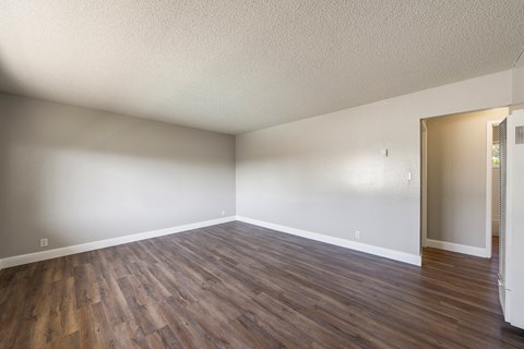A room with wooden flooring and a white ceiling.