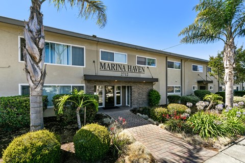 The front of a building named Marina Haven with a clear blue sky in the background.