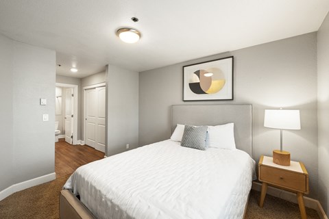 a bedroom with a bed and a nightstand