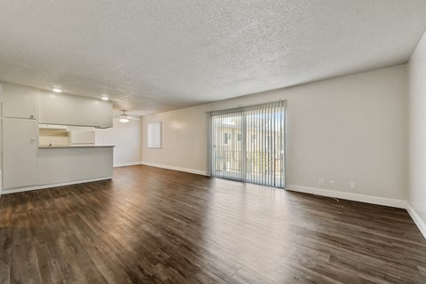 A room with wooden floors and a sliding glass door.