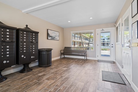 A room with a bench, a door, and a window.