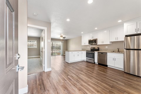 A kitchen with white cabinets and stainless steel appliances.