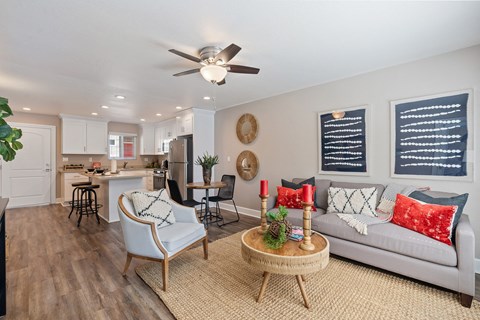 A living room with a white sofa and a wooden coffee table.