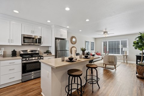 A modern kitchen with white cabinets and a large island.