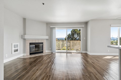 A spacious living room with a fireplace and sliding glass doors.