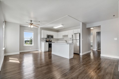 A spacious kitchen with white cabinets and stainless steel appliances.