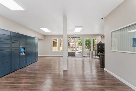 A long hallway with wood floors and white walls.