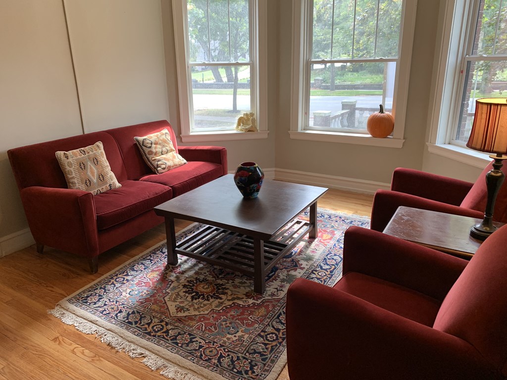 a living room with red couches and a coffee table