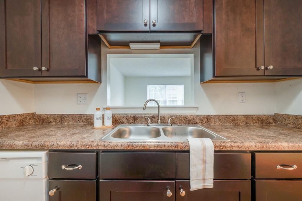 a kitchen with a sink and wooden cabinets