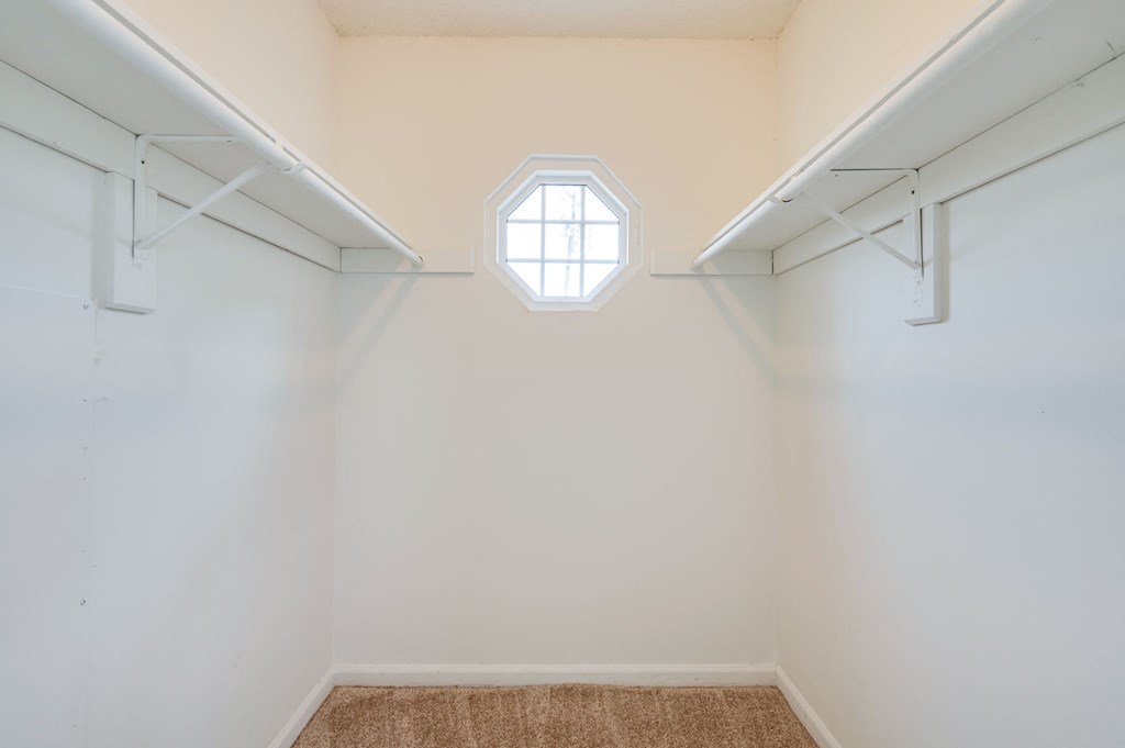 a room with white walls and a window on the ceiling