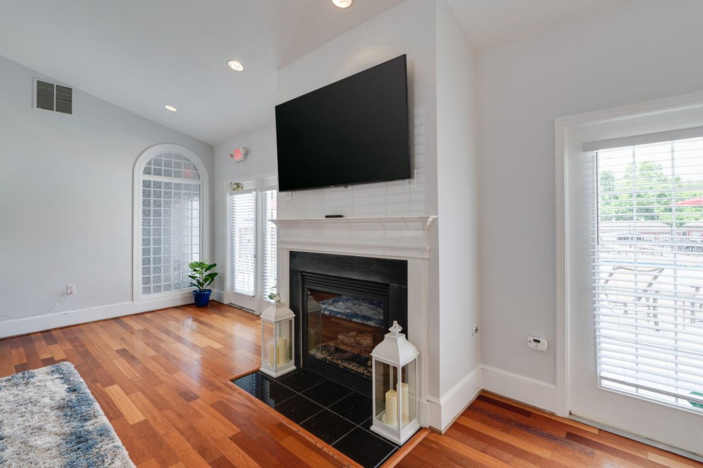 a living room with a fireplace and a tv above it