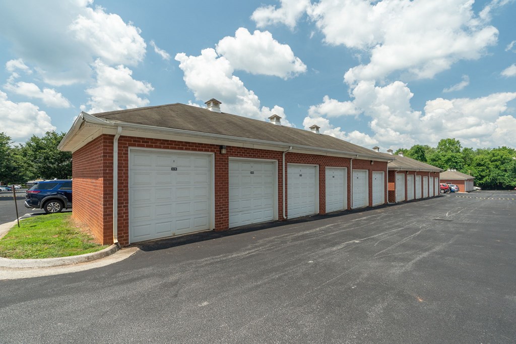 a row of white garage doors on the side of a building