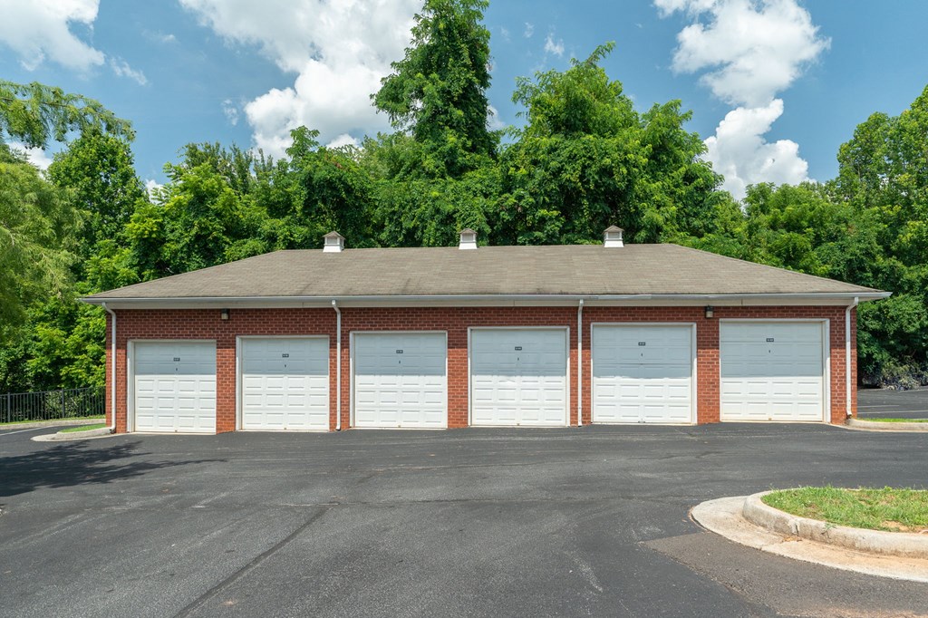 a parking lot with a row of white garage doors