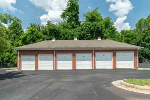 a parking lot with a row of white garage doors