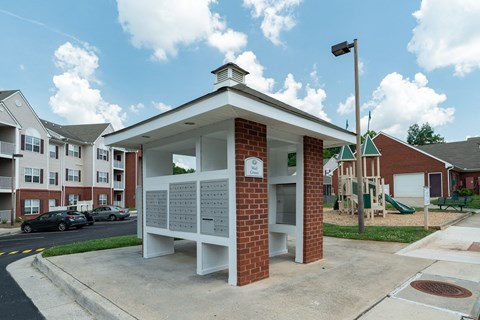 a small white building with a sign on the side of it