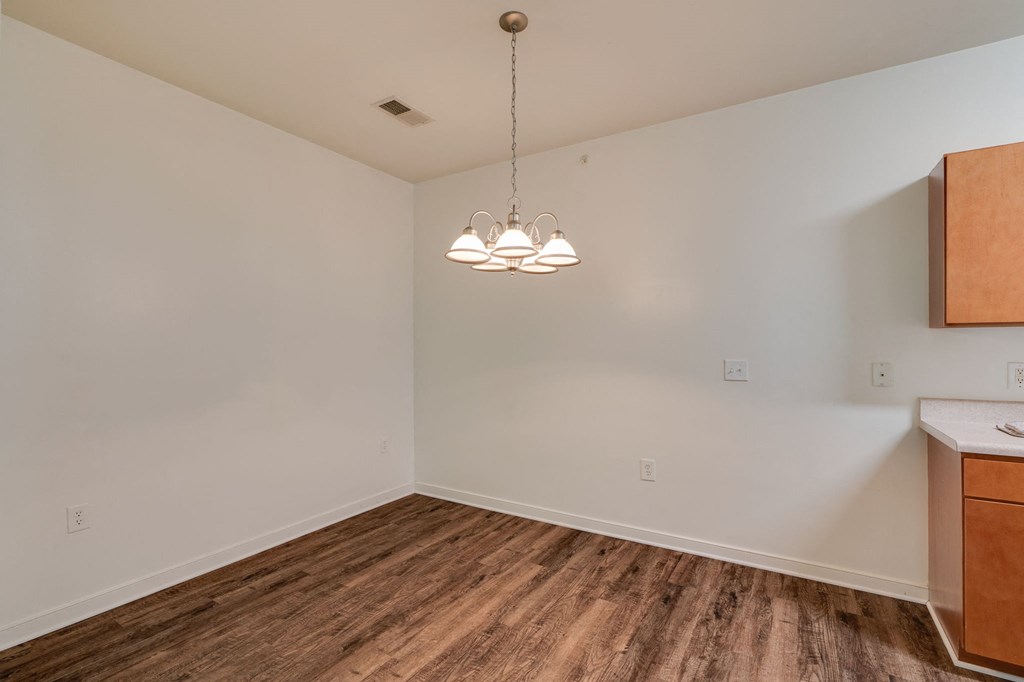 a living room with a wood floor and white walls