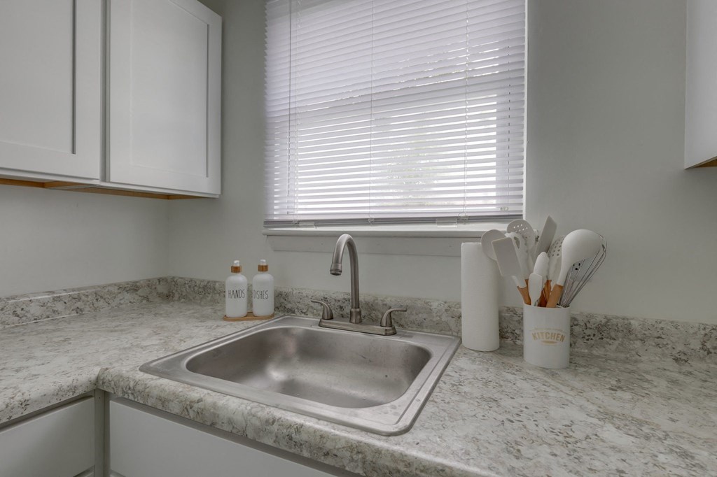 a kitchen with a sink and a window