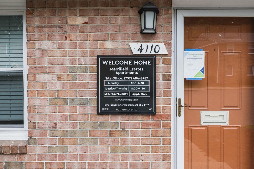 a sign on the side of a brick building saying welcome home