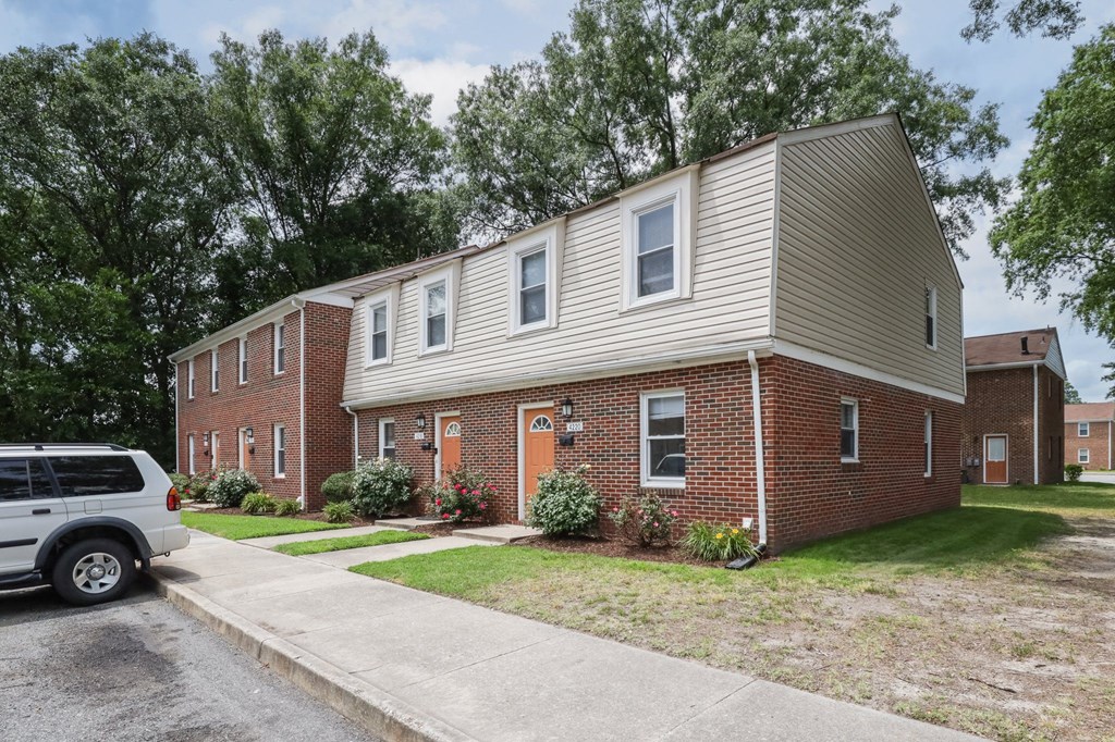 an apartment building with a car parked in front of it