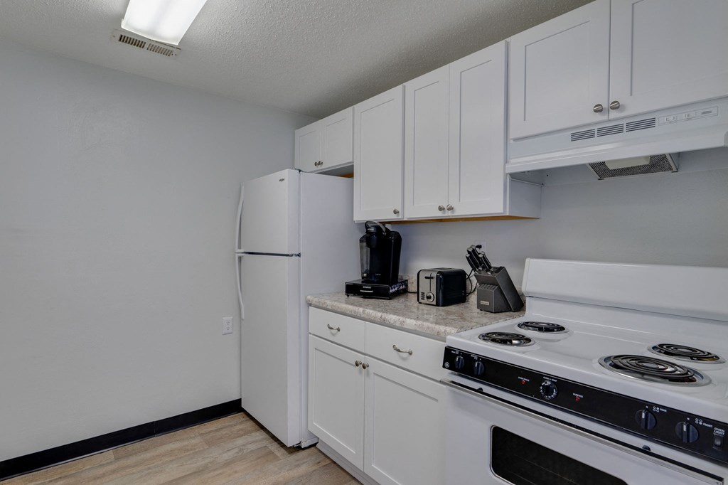 the preserve at ballantyne commons apartment kitchen with white appliances and white cabinets