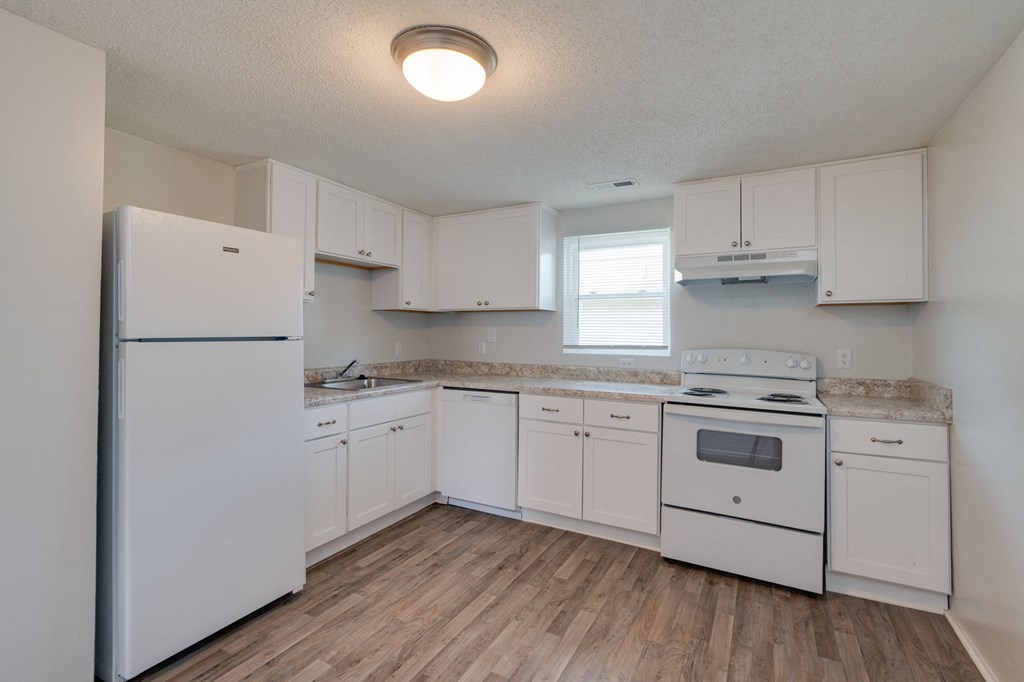 a kitchen with white appliances and white cabinets