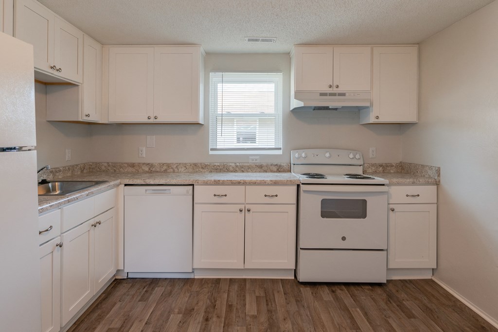 a kitchen with white appliances and white cabinets
