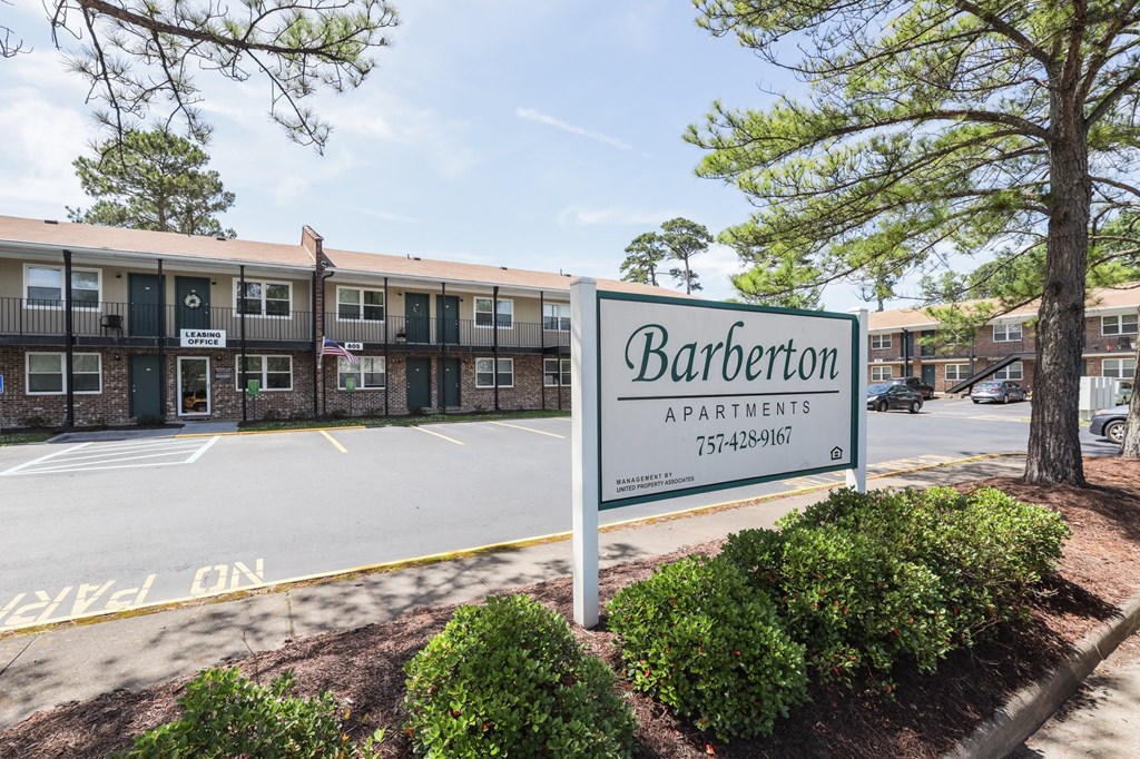 a sign in front of a parking lot