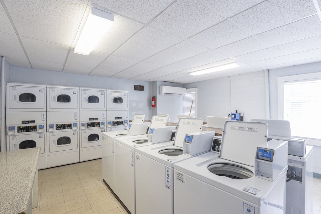 a laundry room with washers and dryers and washing machines