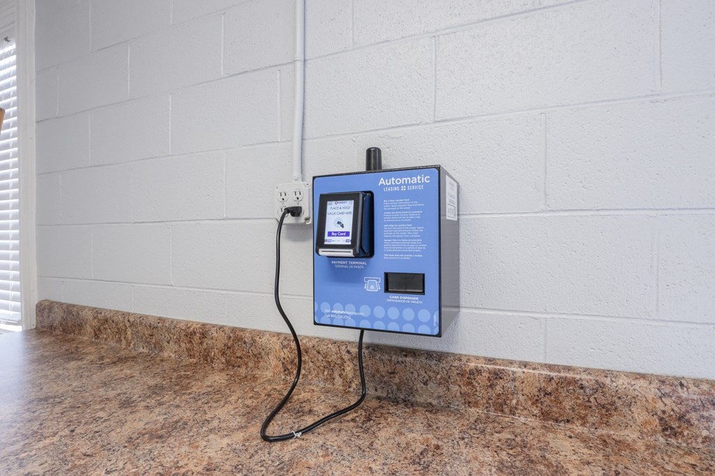 a blue pay phone is plugged into a wall