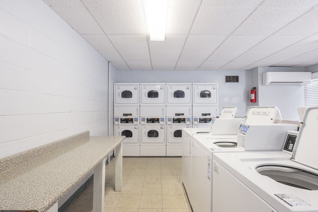 a laundry room with washers and dryers and washing machines