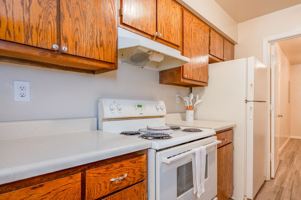 a kitchen with a stove and a refrigerator