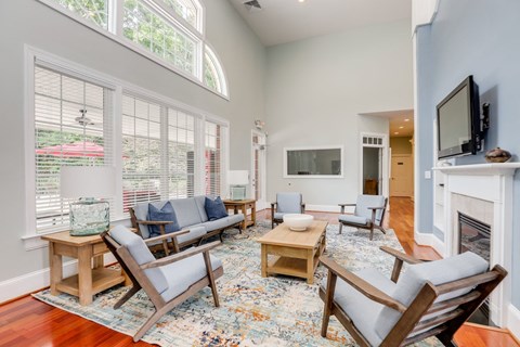 a living room with a fireplace and a large window